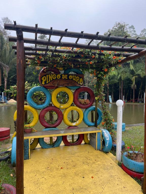 a playground in a park with colorful tires at Pesqueiro Restaurante e Pousada Pingo de Ouro in Piedade