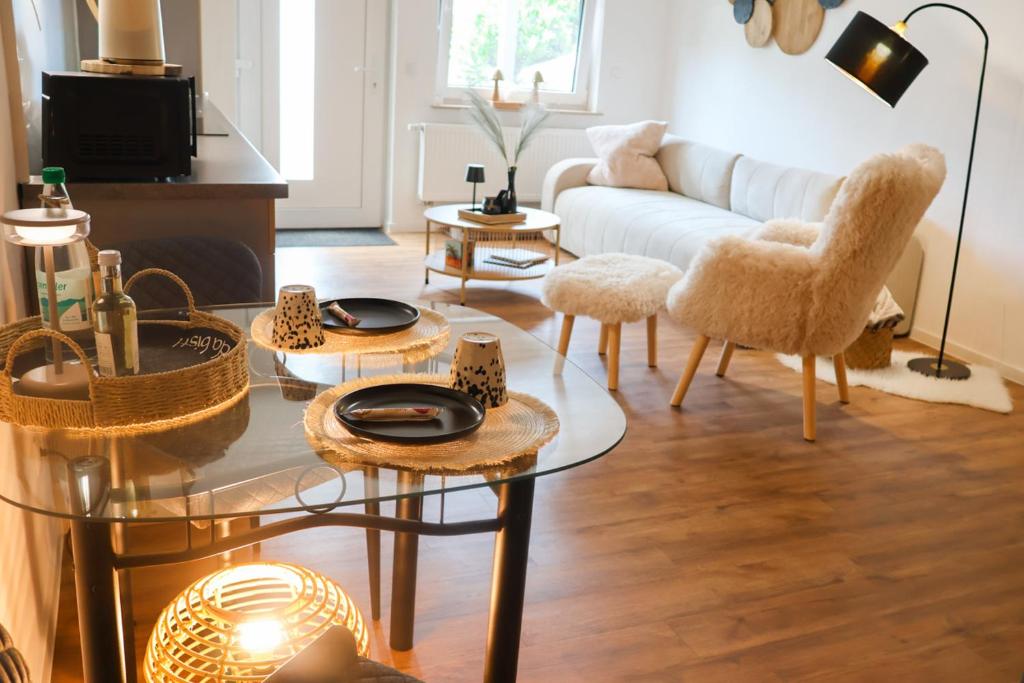 a living room with a couch and tables and chairs at Feines Feriendomizil Waldzauber 2 Horhausen Westerwald in Horhausen