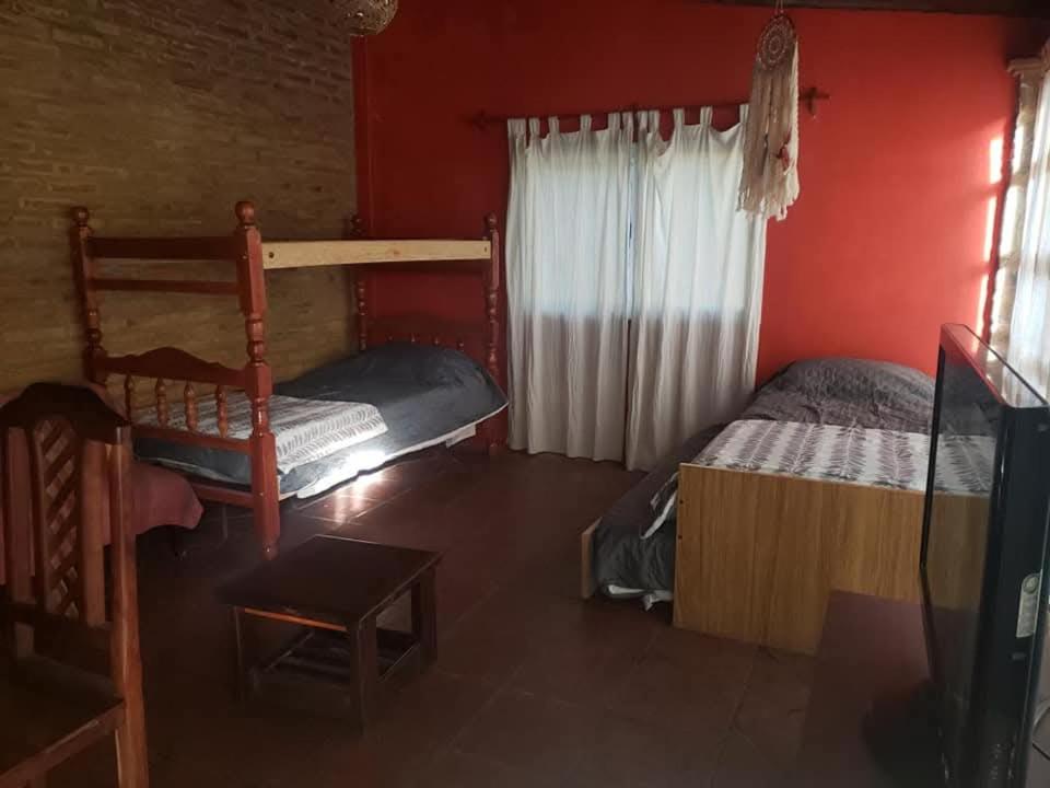 a bedroom with two bunk beds and a red wall at Posada Valentina in San Salvador de Jujuy