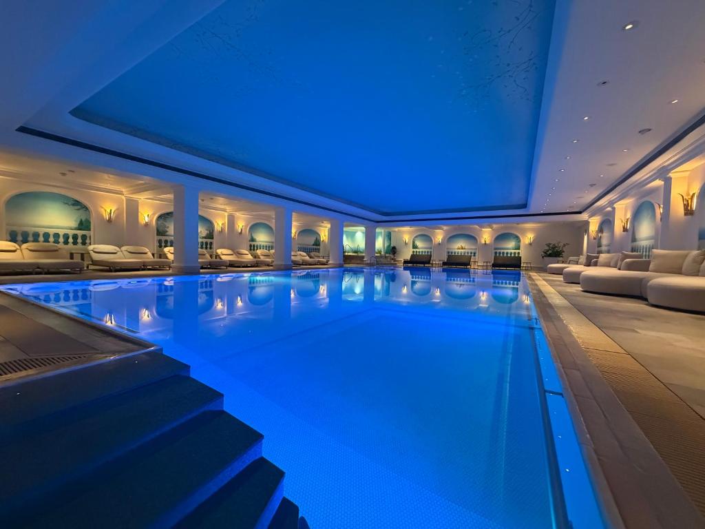 a swimming pool in a hotel with blue lighting at revita - naturresort & spa in Bad Lauterberg