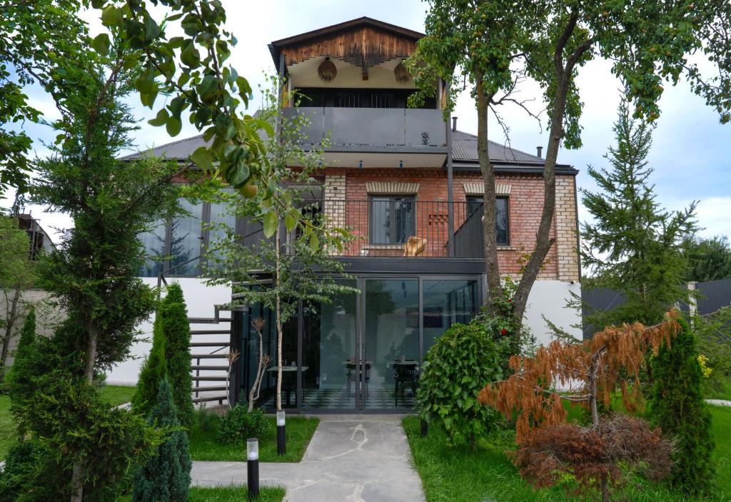 a brick house with a glass facade at Namus House in Stepʼanavan