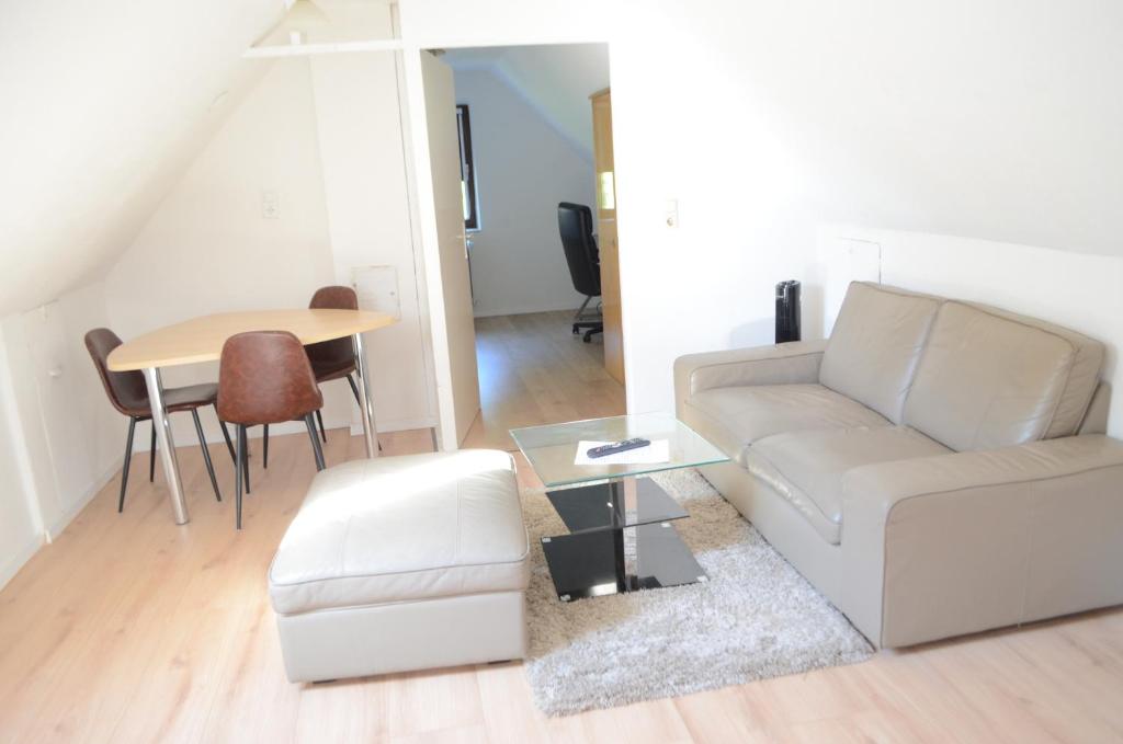 a living room with a couch and a table at Beautiful apartment in Treuchtlingen