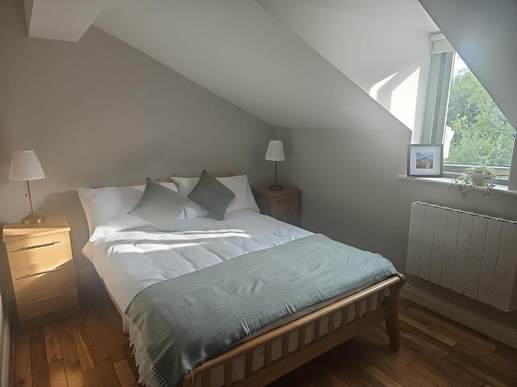 a bedroom with a bed and a window at The Greenmount in Westport