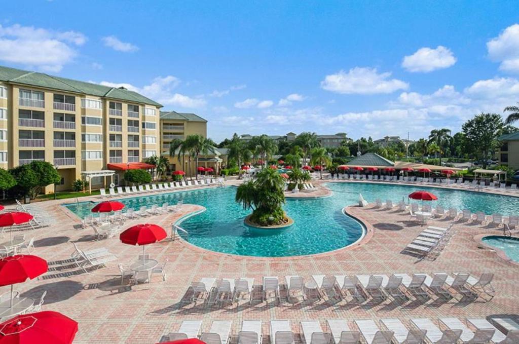 a pool at a resort with chairs and umbrellas at Silver Lake Resort in Orlando