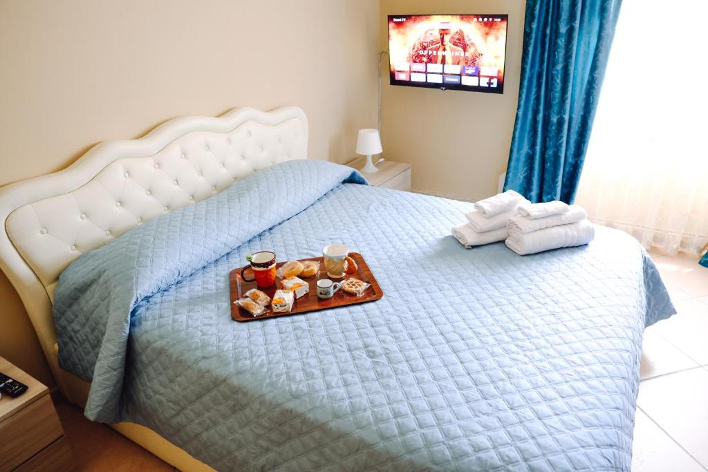 a bed with a tray of food on it at Raggio di sole in Catania