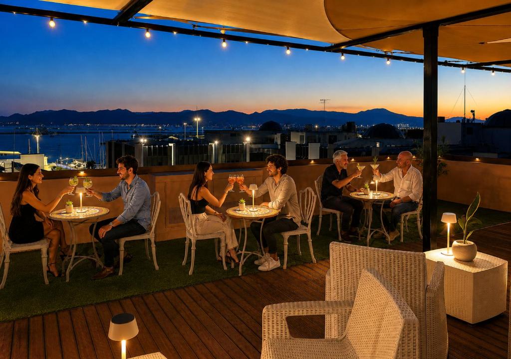 a group of people sitting at tables on a patio at My exclusive cavour loft da sogno a cagliari in Cagliari
