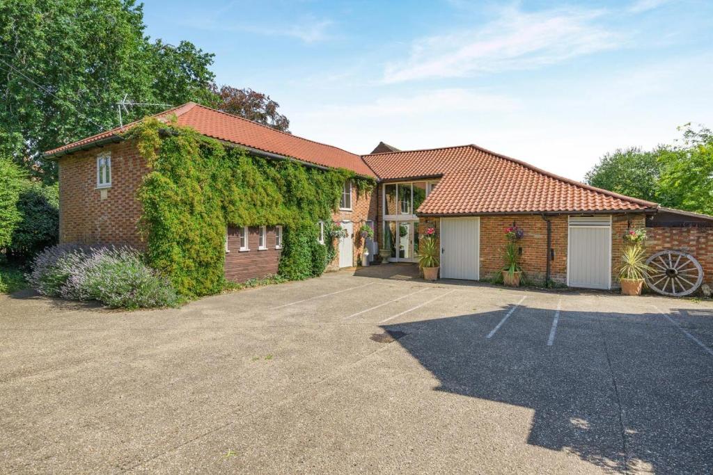 a brick house with ivy on the side of it at 2 Bed in Thetford oc-57886 in Saham Toney