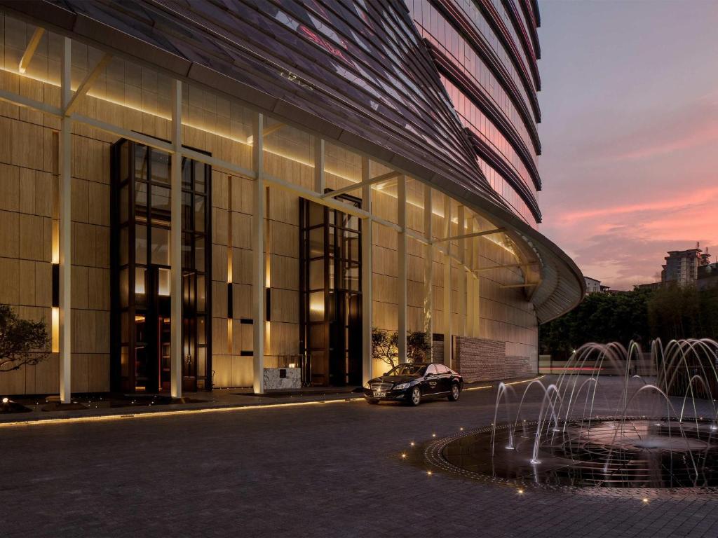 a car parked in front of a building with a fountain at Sofitel Foshan Shunde in Shunde