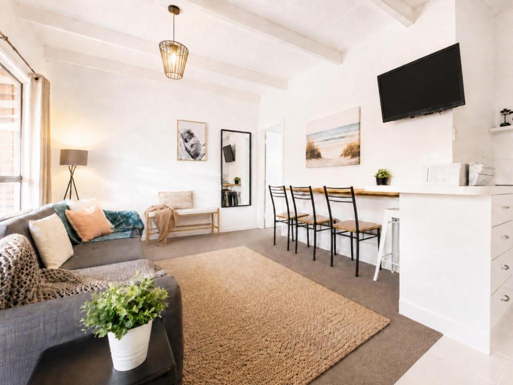 a living room with a couch and a table at Prom Coast Apartments in Sandy Point