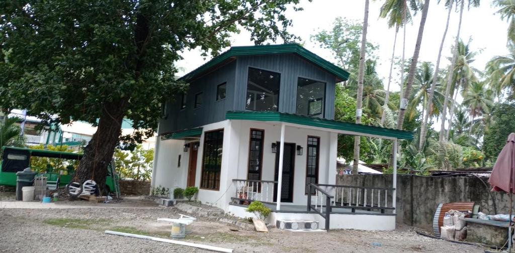 a small house with a green roof at Seaside traveler's Inn by Camiguin Island Home in Catarman