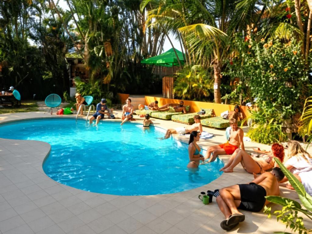 a group of people sitting in a swimming pool at Costa Rica Backpackers in San José