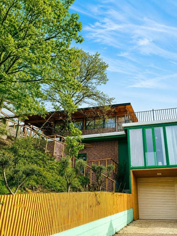 a house with a fence in front of it at Green Hill Villa in Tirana