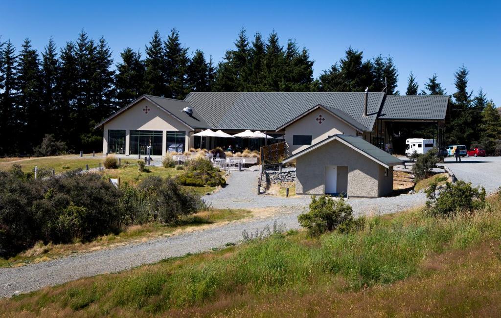 a building on a road with trees in the background at Glentanner Park Centre in Glentanner