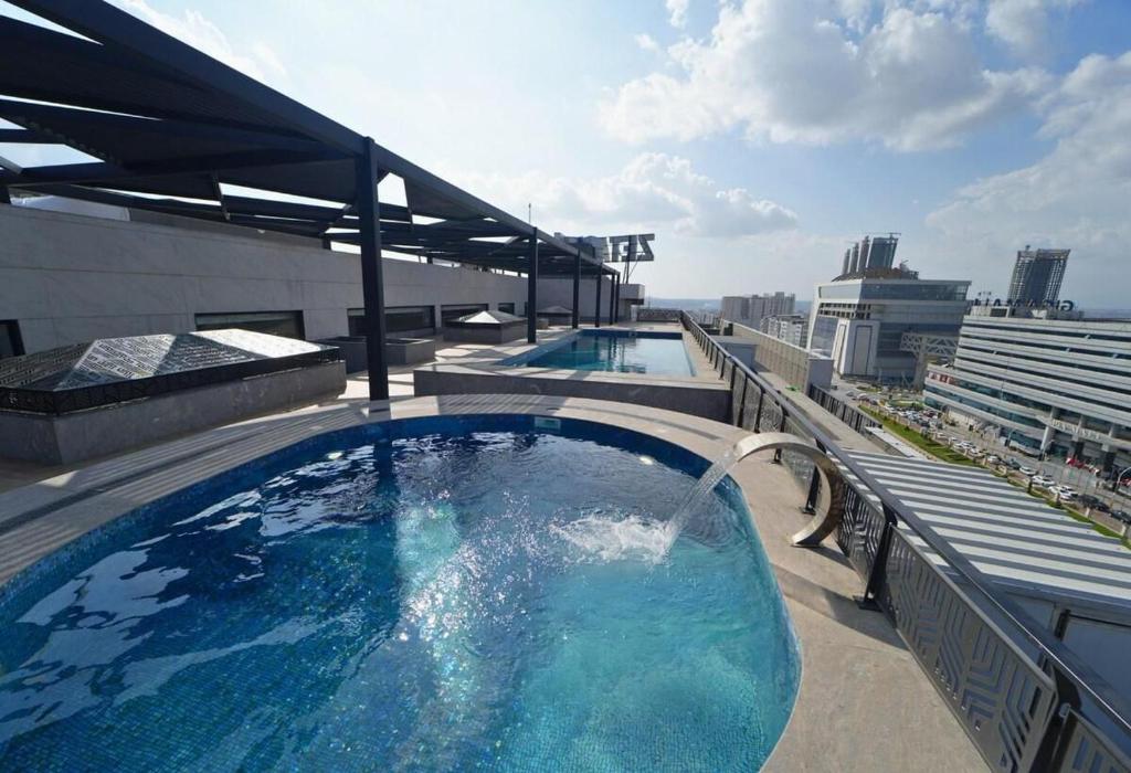 a large swimming pool on top of a building at White420 apartment in Rawalpindi