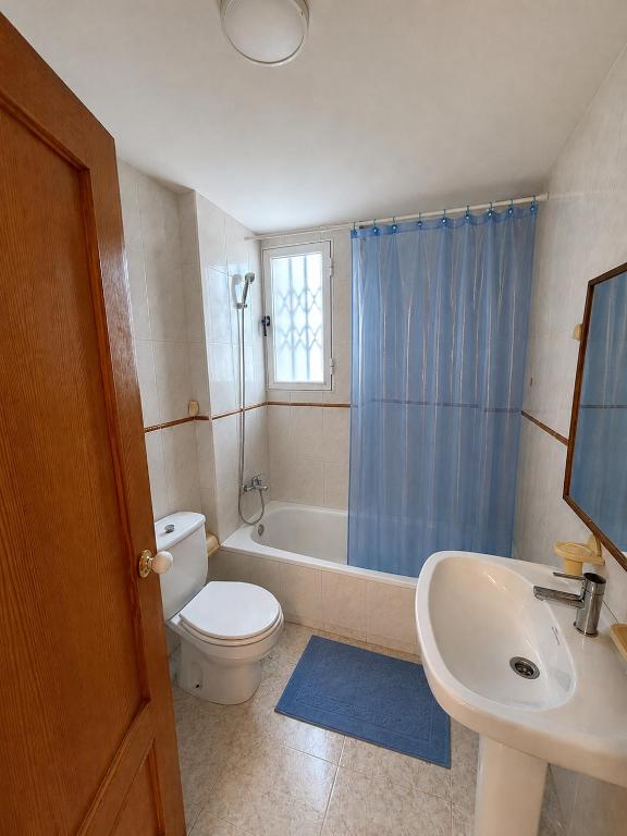 a bathroom with a toilet and a sink and a tub at Villa Bella in Los Altos