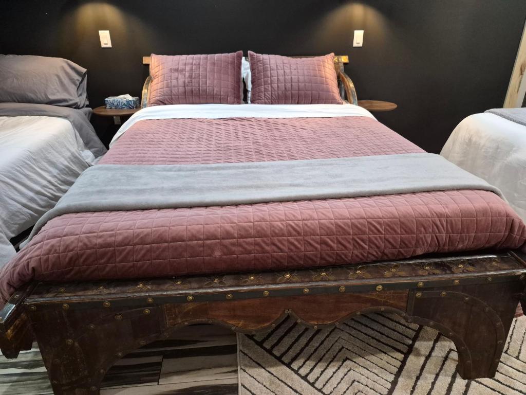 a bedroom with a large bed with a wooden frame at Seigneurie de Valdombre in Lévis