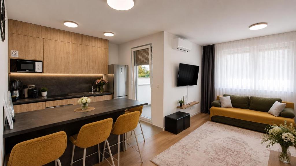 a living room with a couch and a table and chairs at Apartman PEPI LUXURY in Novi Zagreb