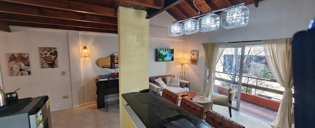 a living room with a couch and a tv and a window at Recovas III in Pilar