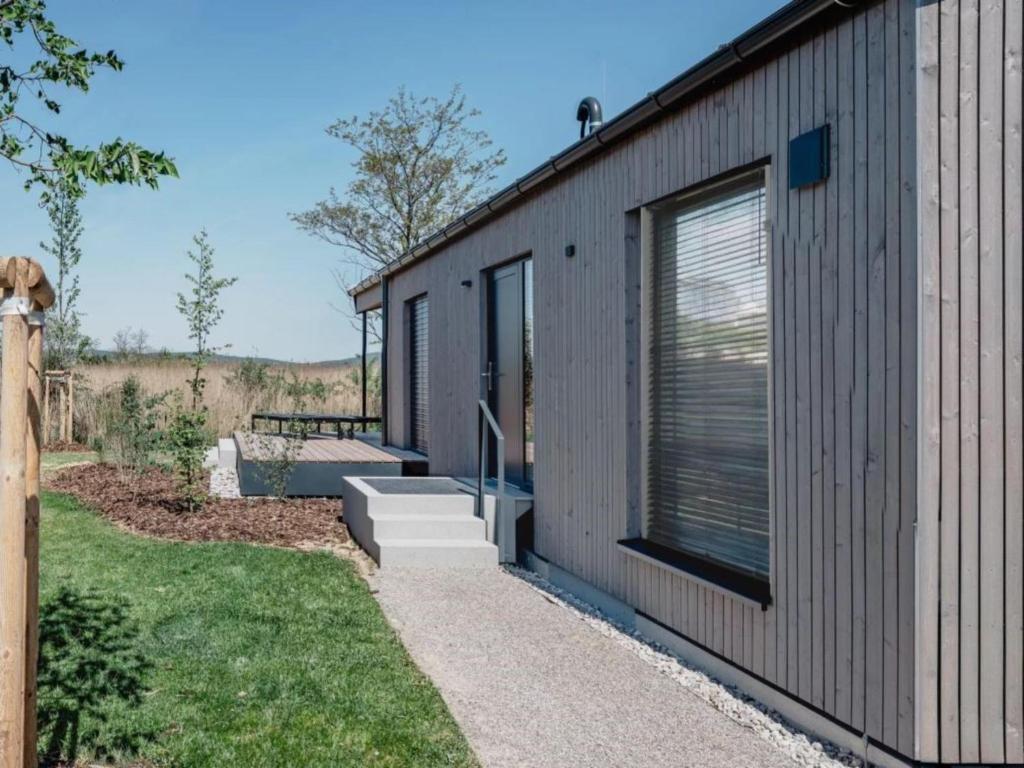 a small house with a pathway leading to the front door at Guesthouse Naturgarten in Breitenbrunn