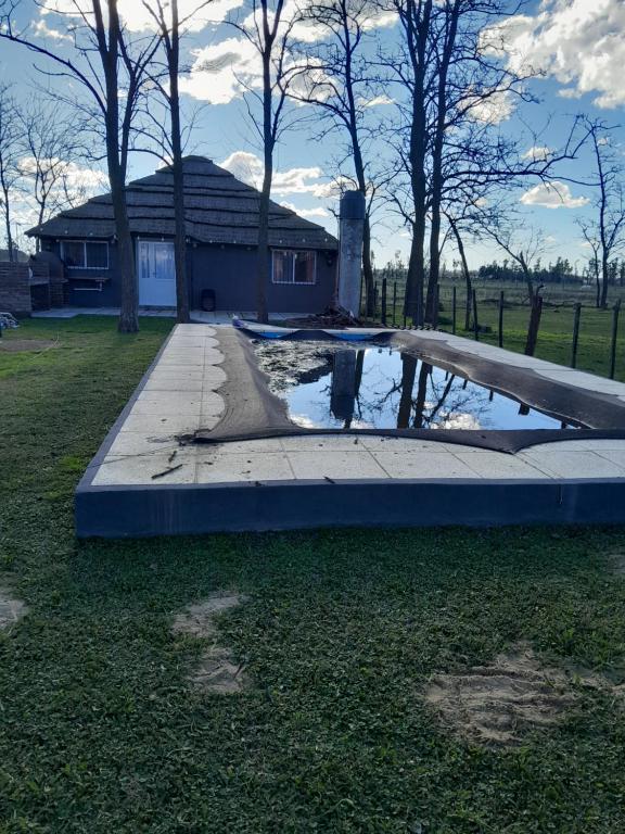 a pool of water in front of a house at Quinta Doña Delia in Agote