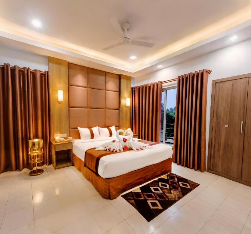 a bedroom with a large bed and a large window at Green Goose by Lakeshore Dhaka in Dhaka