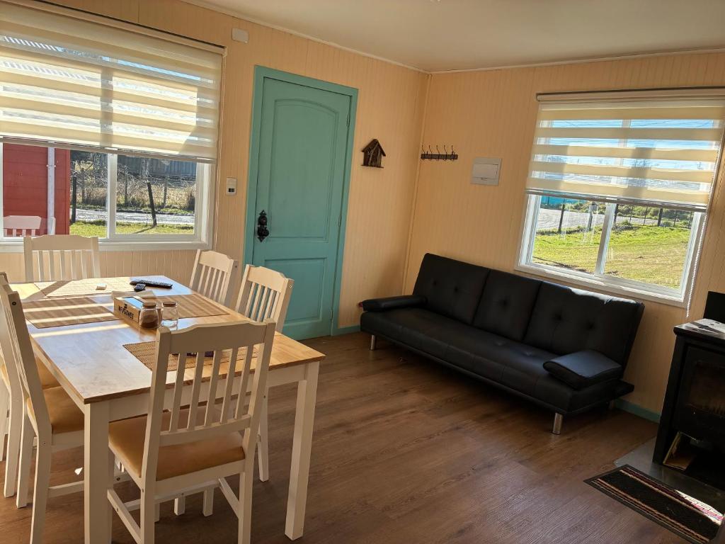 a living room with a table and a couch at cabañas notuco in Natuco