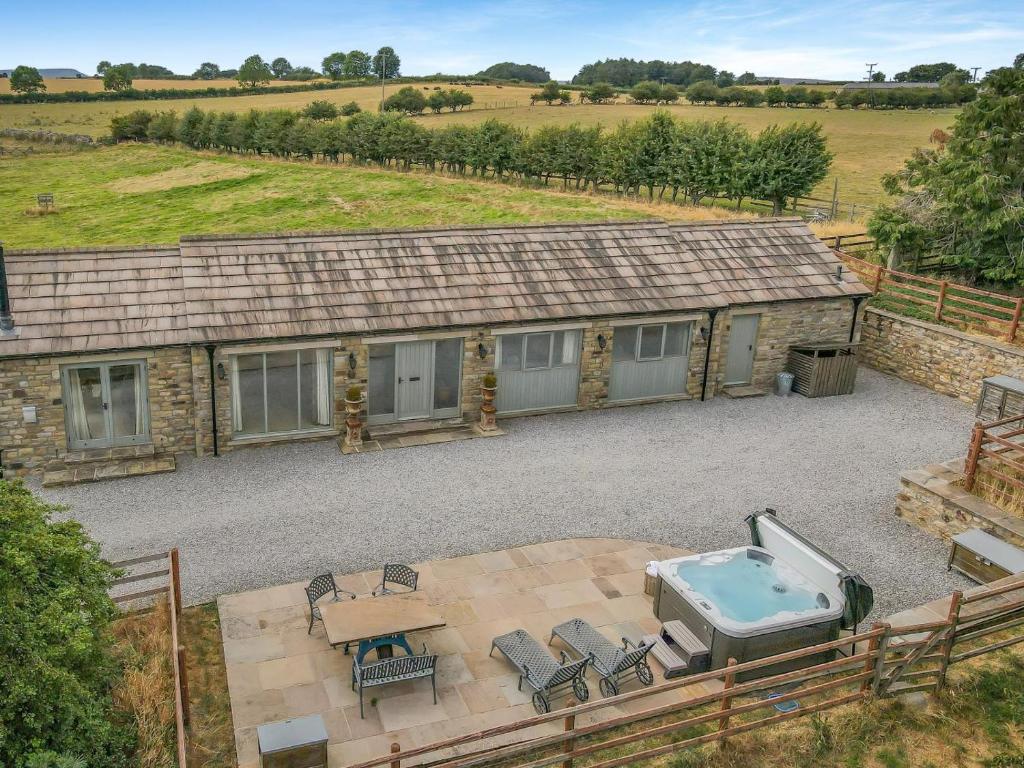 an aerial view of a house with a hot tub and patio at 2 Bed in Leyburn oc-g0099 in Constable Burton