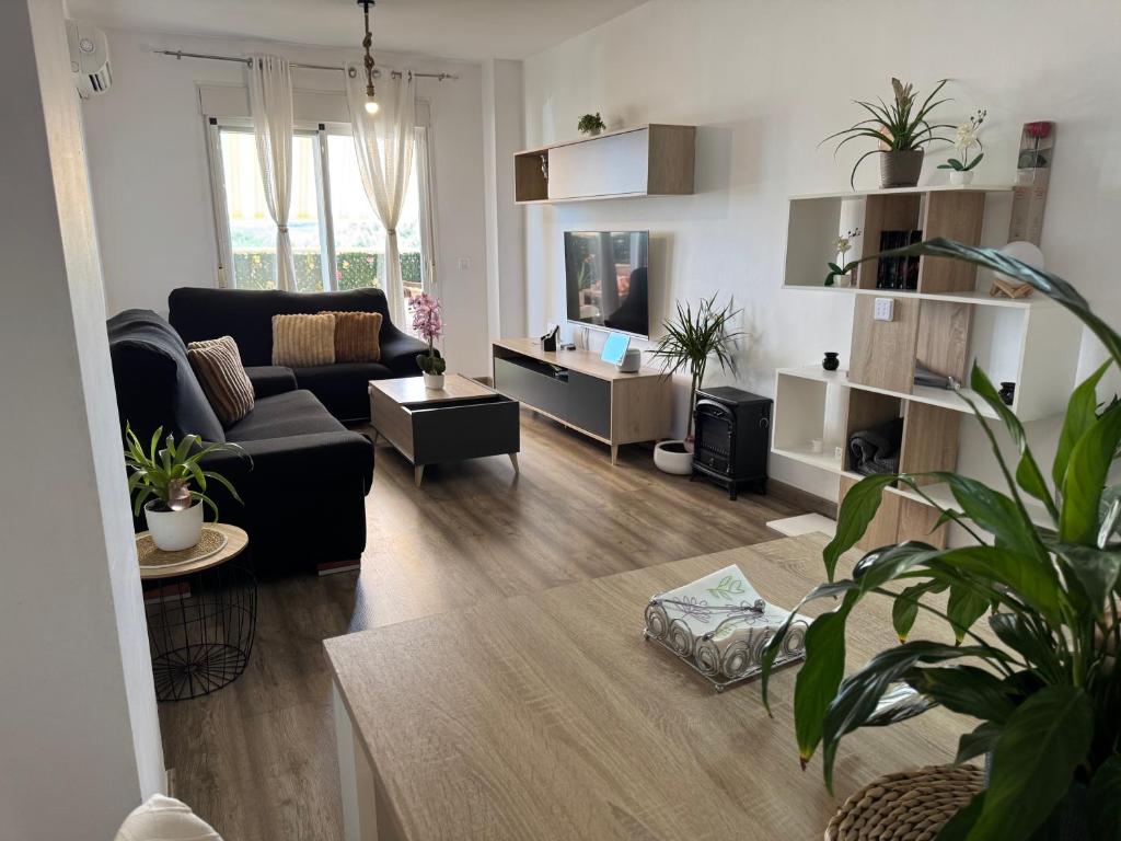 a living room with a couch and a table at Acogedor Apartamento in Almerimar