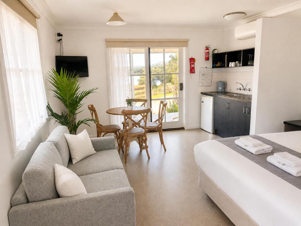 a living room with a couch and a table at BIG4 Robe Lakeside Tourist Park in Robe