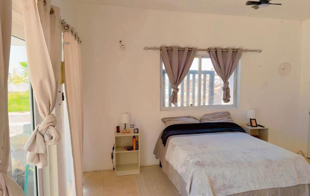 a bedroom with a bed and a window at Old Harbour Oasis in Old Harbour