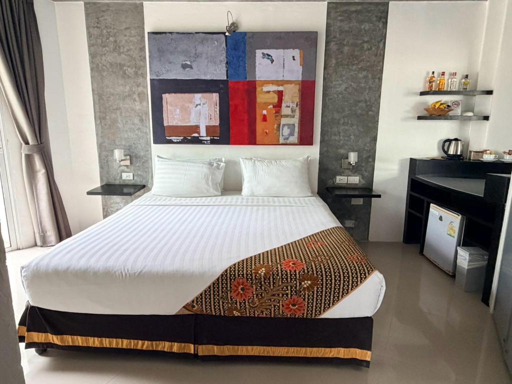a bedroom with a large bed in a room at The Front Hotel and Apartments in Patong Beach