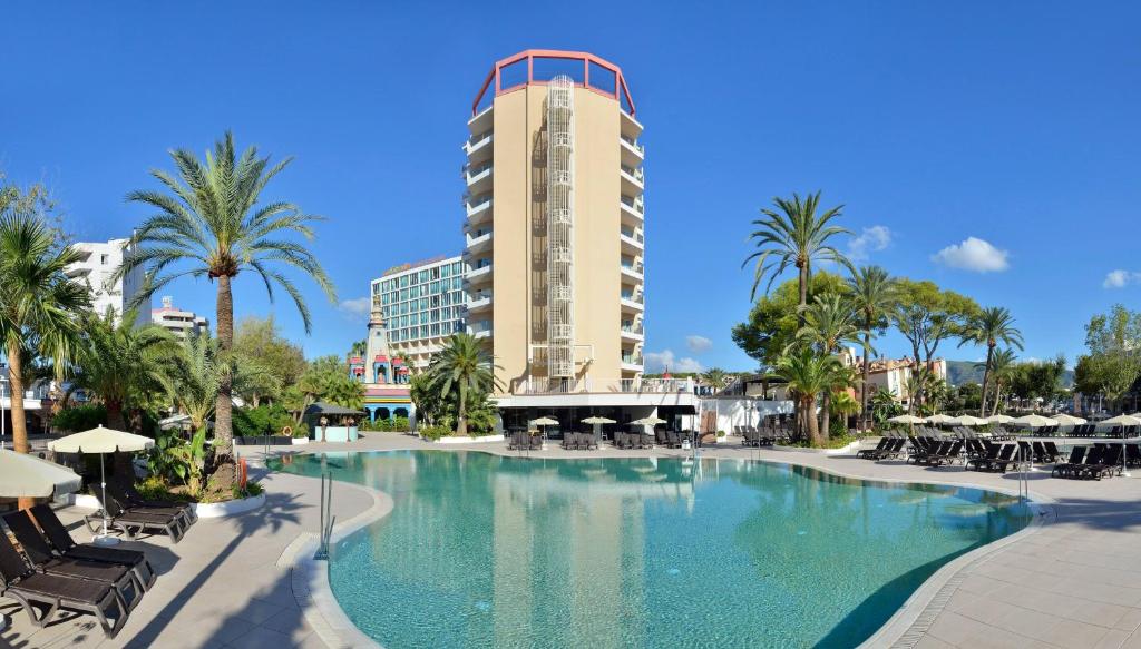 a large swimming pool with a hotel in the background at SOL by Meliá Katmandú Park and Resort in Magaluf