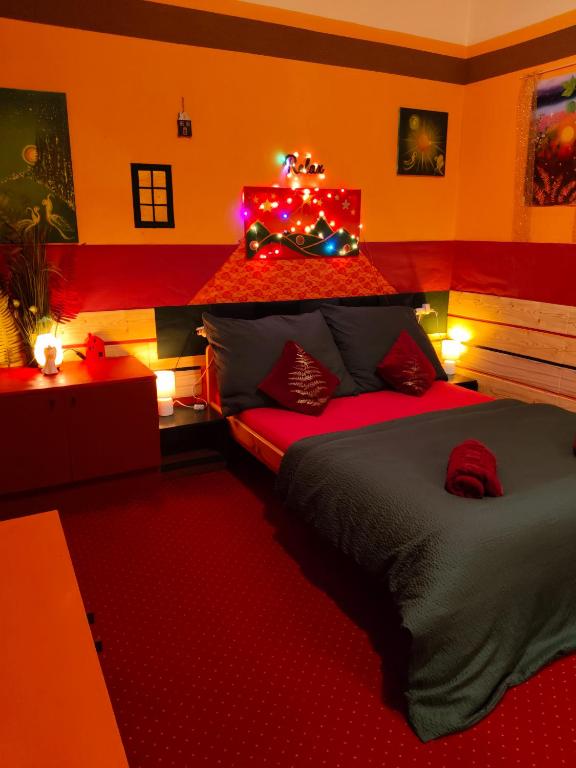 a bedroom with two beds with christmas lights on it at Pension Relax in Litoměřice