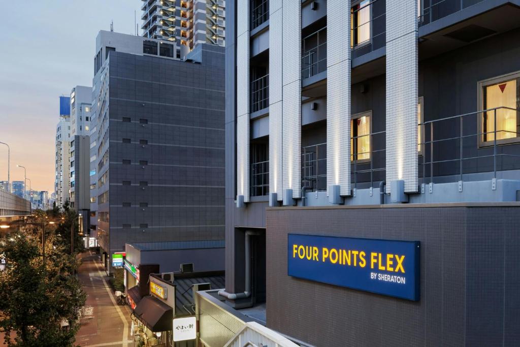 a sign on the side of a building at Four Points Flex by Sheraton Shin Osaka in Osaka