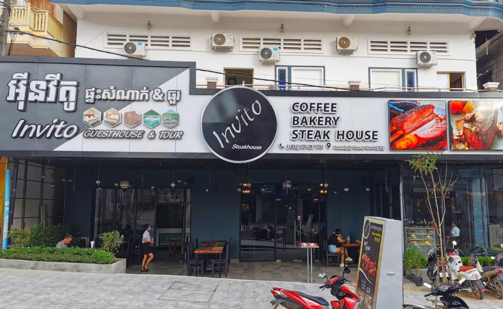 a building with a coffee bakery and a steak house at Invito Guesthouse in Sihanoukville