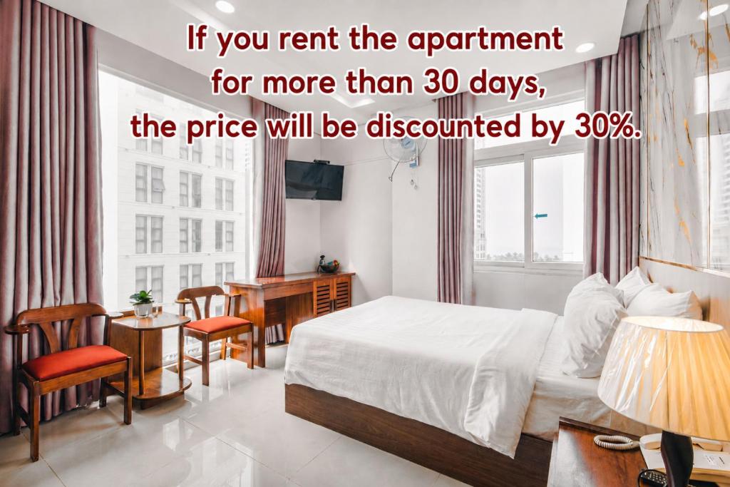a hotel room with a bed and a desk and a table at Kiên Cường 2 Hotel & Apartment in Danang
