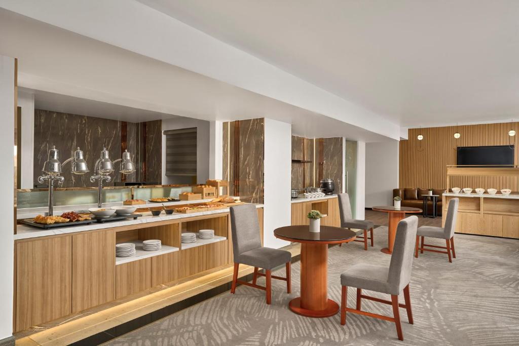 a kitchen with chairs and a table in a room at Sheraton Hanoi Hotel in Hanoi