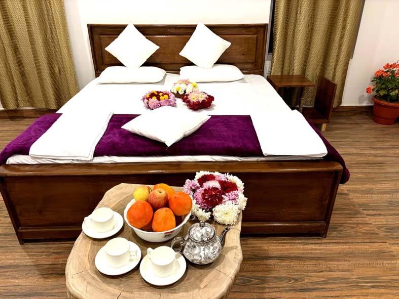 a hotel room with a bed with a tray of fruit at Kashmir Beautiful Villa in Srinagar