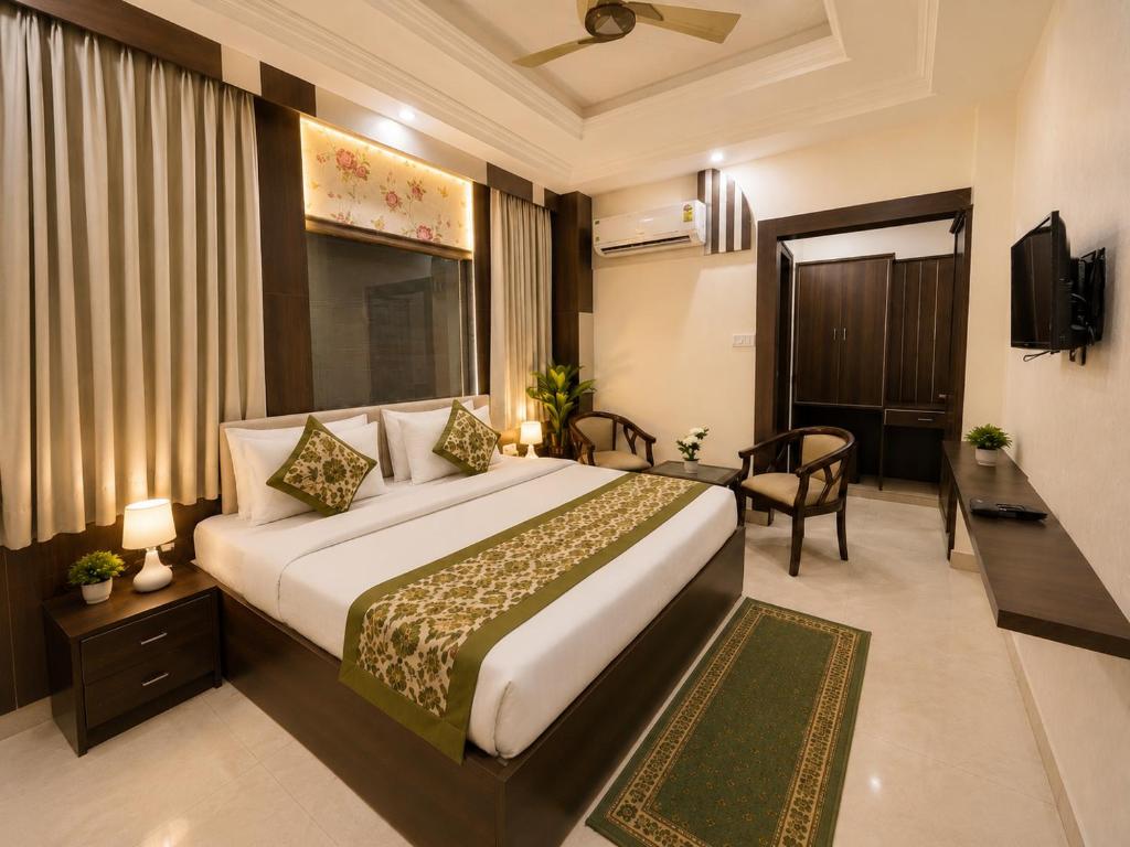 a hotel room with a large bed and a television at Hotel Ramawati Near Ganga Ghat, Haridwar in Haridwār