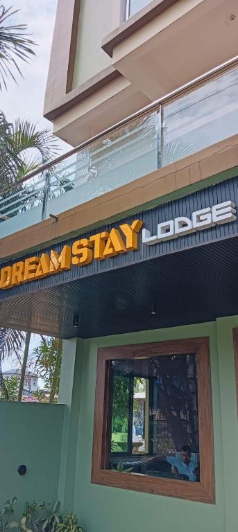 a sign over a window of a restaurant at Dream Stay Lodge in Guwahati