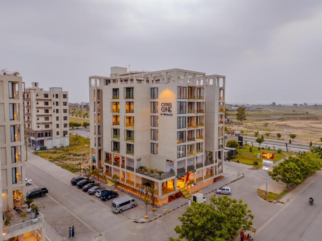 an overhead view of a white building with a parking lot at Cyrus One By Trivelles in Islamabad