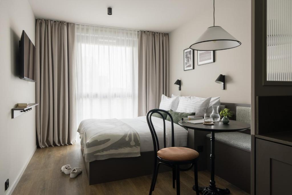 a hotel room with a bed and a table at Bob W Vienna Döbling in Vienna