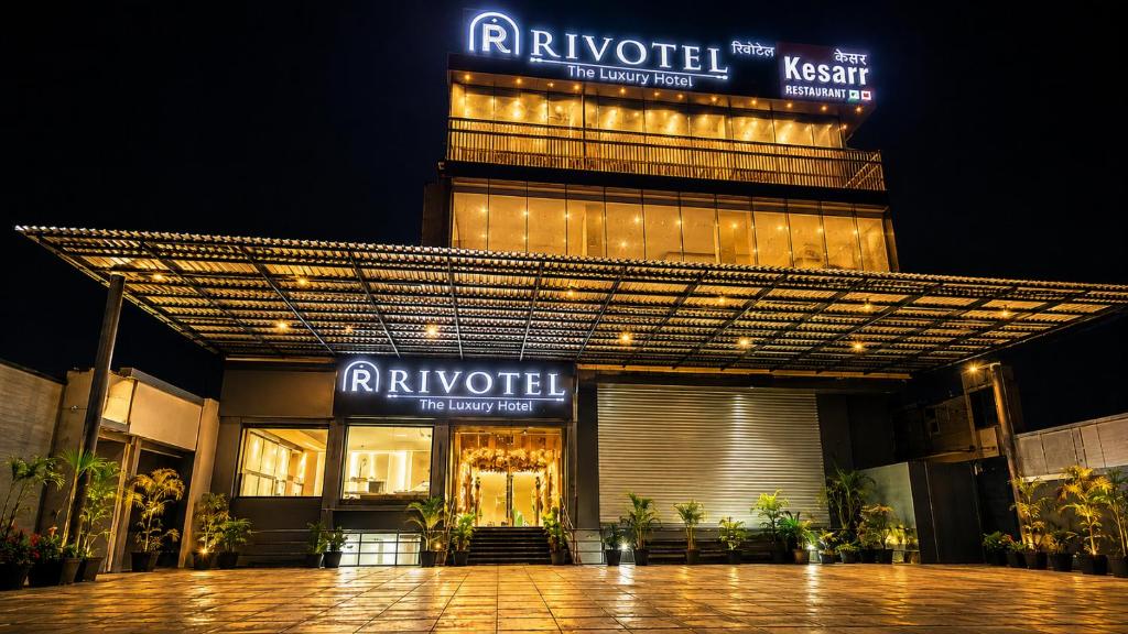 a building with a sign that reads riyaushkritkritkritkritkritkrit at Rivotel The Luxury Hotel in Chākan