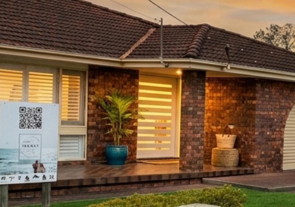 a house with a sign in front of it at 100m to Beach&Shop Spacious Pristine One Story Family Home in Batemans Bay