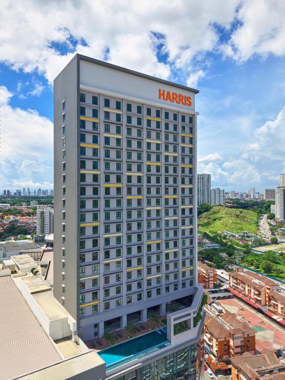 a large hotel building with a harris sign on it at Harris Hotel & Conventions Sunshine Penang in Ayer Itam