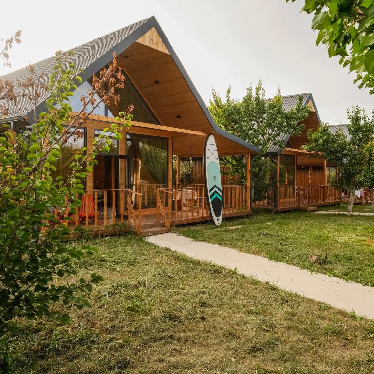 a house with a surfboard parked outside of it at Silence Houses in Tossor