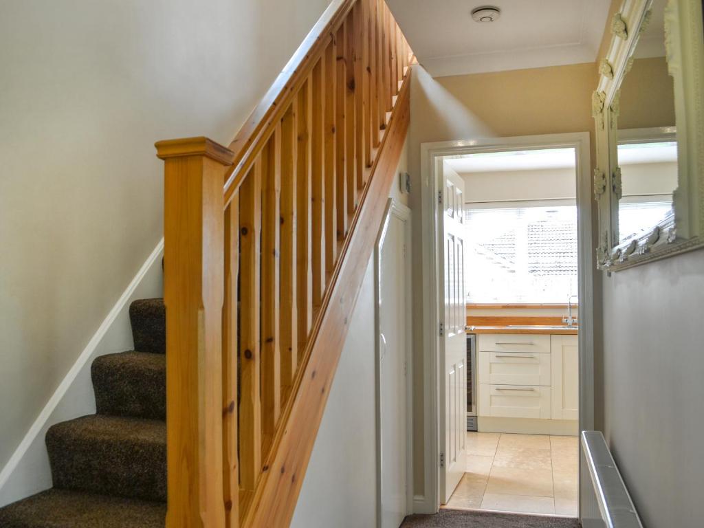 a staircase in a home with wooden railings at Oceans 44 in Bridlington