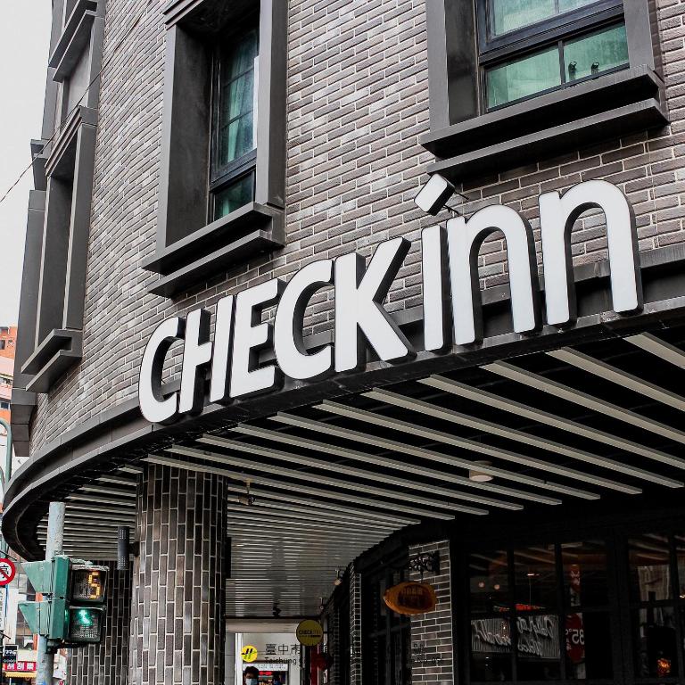 a cheetah sign on the side of a building at CHECK inn Taichung Ziyou in Taichung
