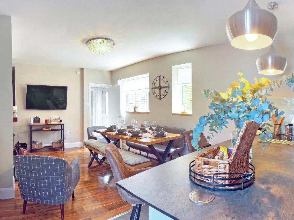a living room with a table and chairs and a dining room at Beaconsfield House in Mundesley