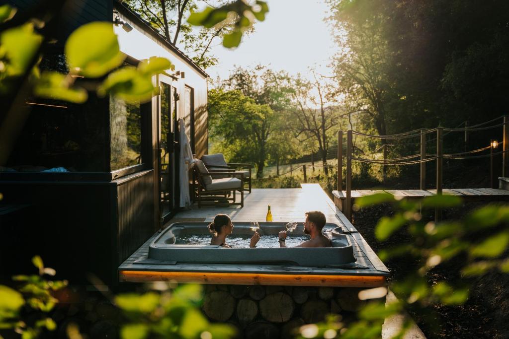 a man and a child sitting in a bath tub at Feelmore Tiny House Karancsalja in Karancsalja
